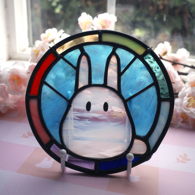 Circular stained glass piece with a rainbow frame and Chibi Totoro in the middle.