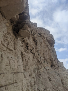 a munumental rock wall with a lot of holes in it