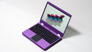 MNT Reform Next open hardware laptop with purple aluminum body. 3-button glass trackpad and rgb backlight mechanical keyboard (here with purple backlight).