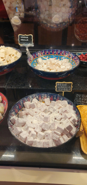 photo from a display case at a shop called Aegean Delights in the Castro in San Francisco: two large bowls of completely normal looking turkish delight, labeled "Narnia Vanilla" and "Rose Narnia Cubes" respectively