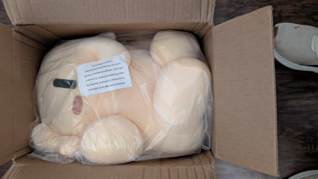 Mastodon plush in federation beige, stuck in a box