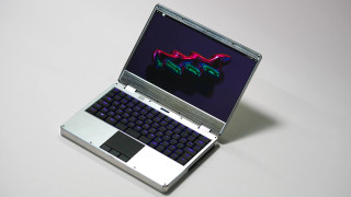 MNT Reform Next open hardware laptop with raw untreated aluminum body. 3-button glass trackpad and rgb backlight mechanical keyboard (here with purple/blue backlight).